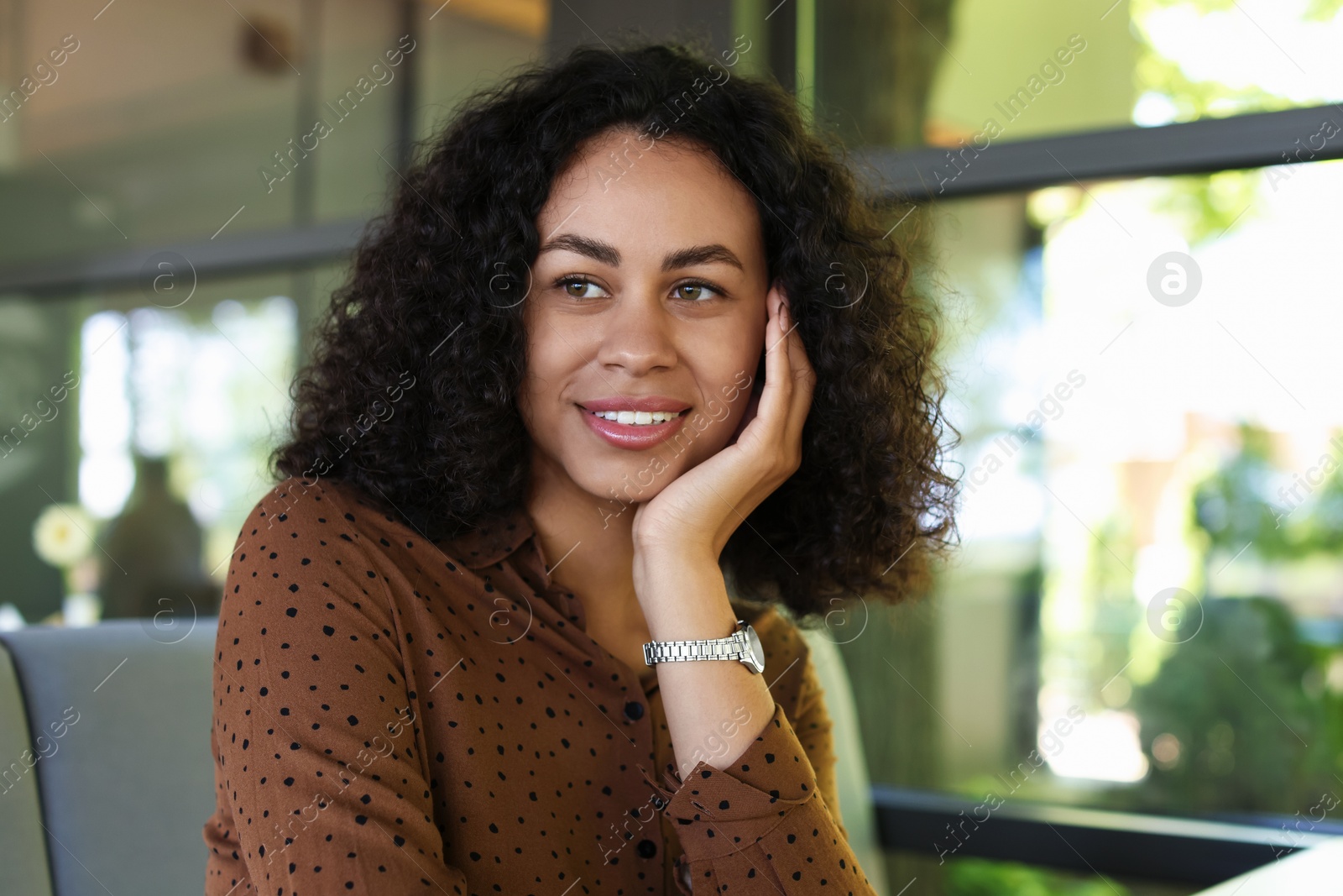 Portrait of smiling Latin American woman in cafe Photo of Portrait of smiling Latin American woman in cafe