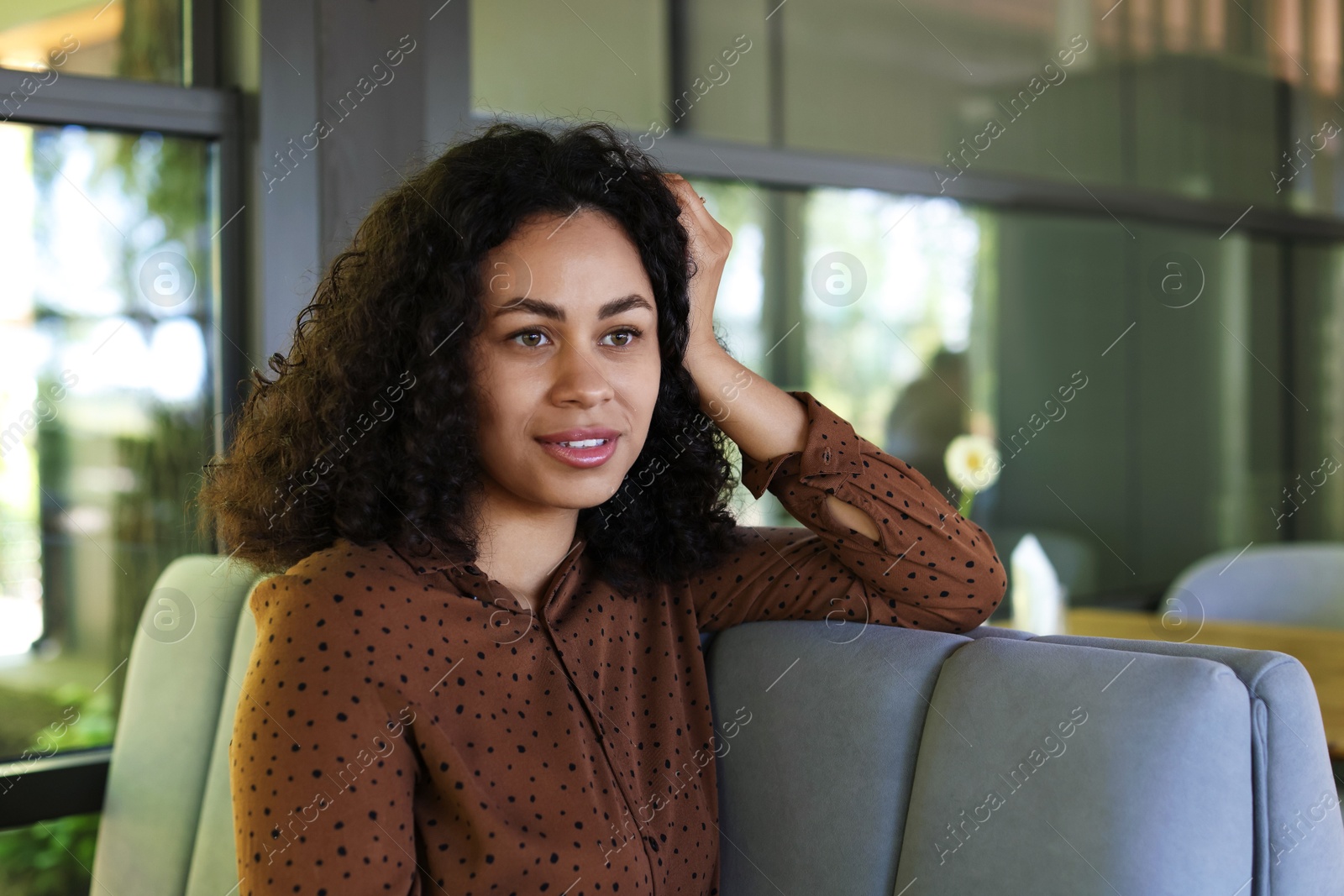 Portrait of smiling Latin American woman in cafe Photo of Portrait of smiling Latin American woman in cafe