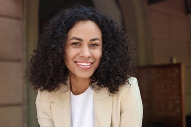 Photo of Portrait of smiling Latin American woman outdoors