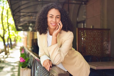 Photo of Portrait of smiling Latin American woman outdoors