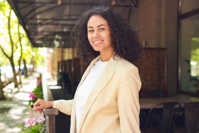 Photo of Portrait of smiling Latin American woman outdoors