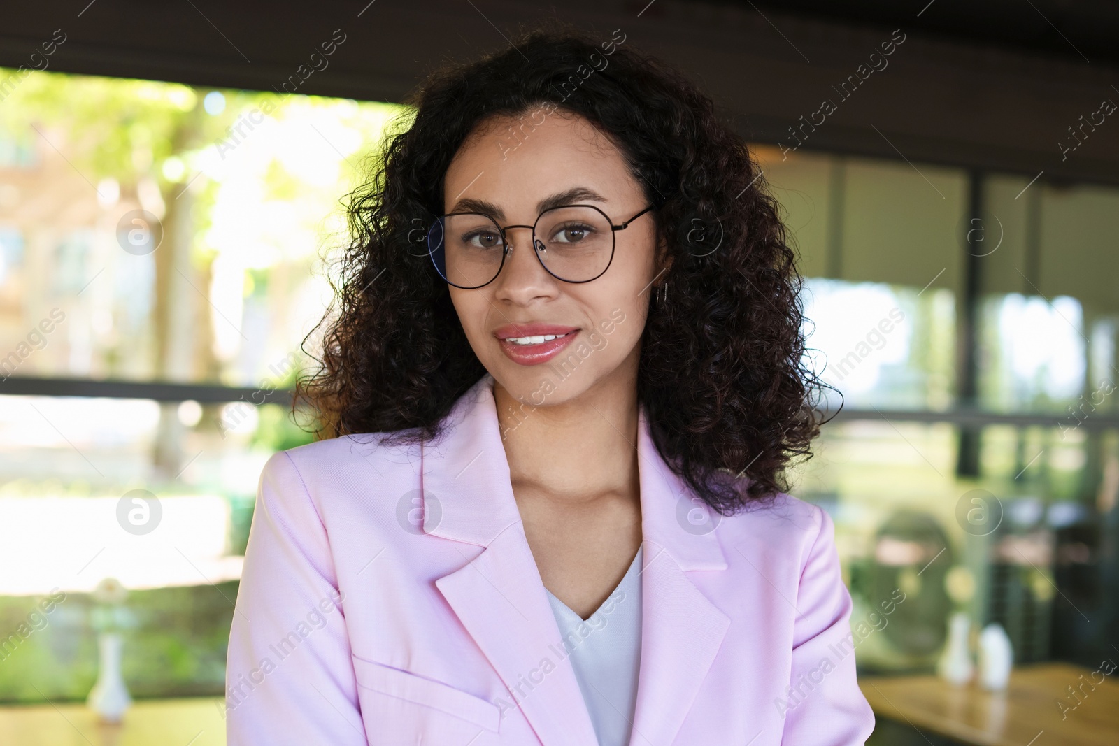 Portrait of smiling Latin American woman in cafe Photo of Portrait of smiling Latin American woman in cafe