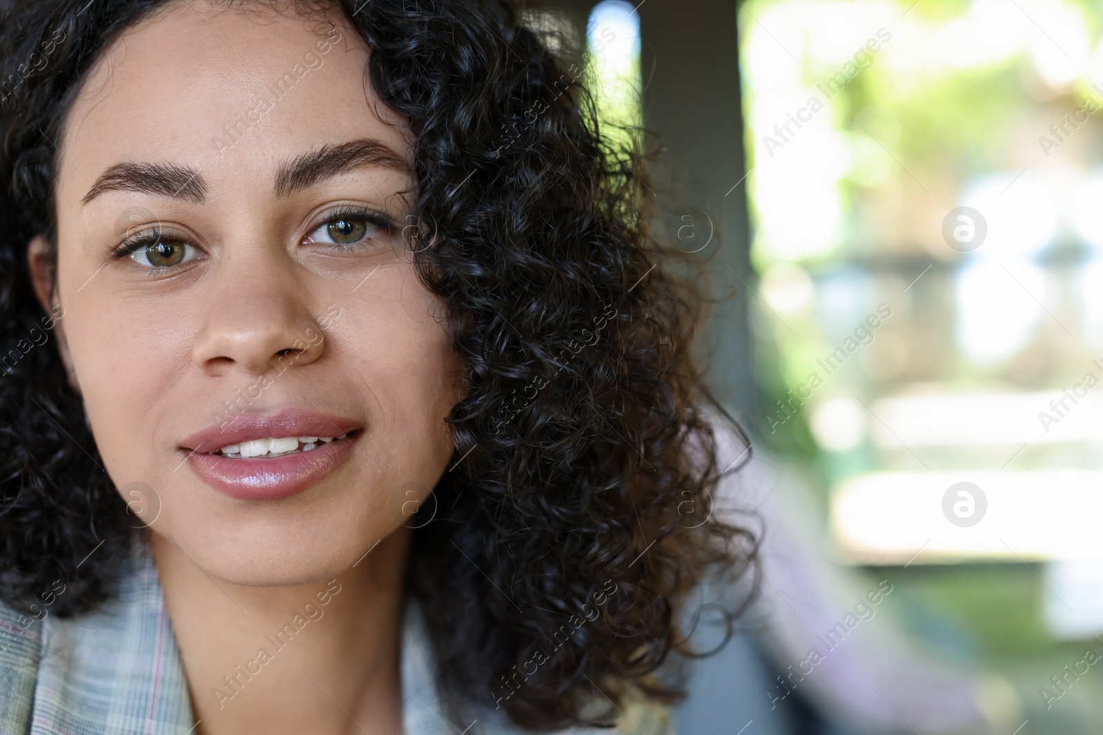 Portrait of smiling Latin American woman on blurred background, closeup. Space for text Photo of Portrait of smiling Latin American woman on blurred background, closeup. Space for text