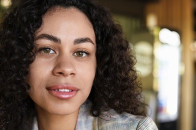 Photo of Portrait of beautiful Latin American woman on blurred background, closeup