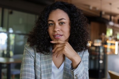 Photo of Portrait of beautiful Latin American woman in cafe