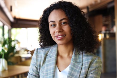 Photo of Portrait of smiling Latin American woman in cafe