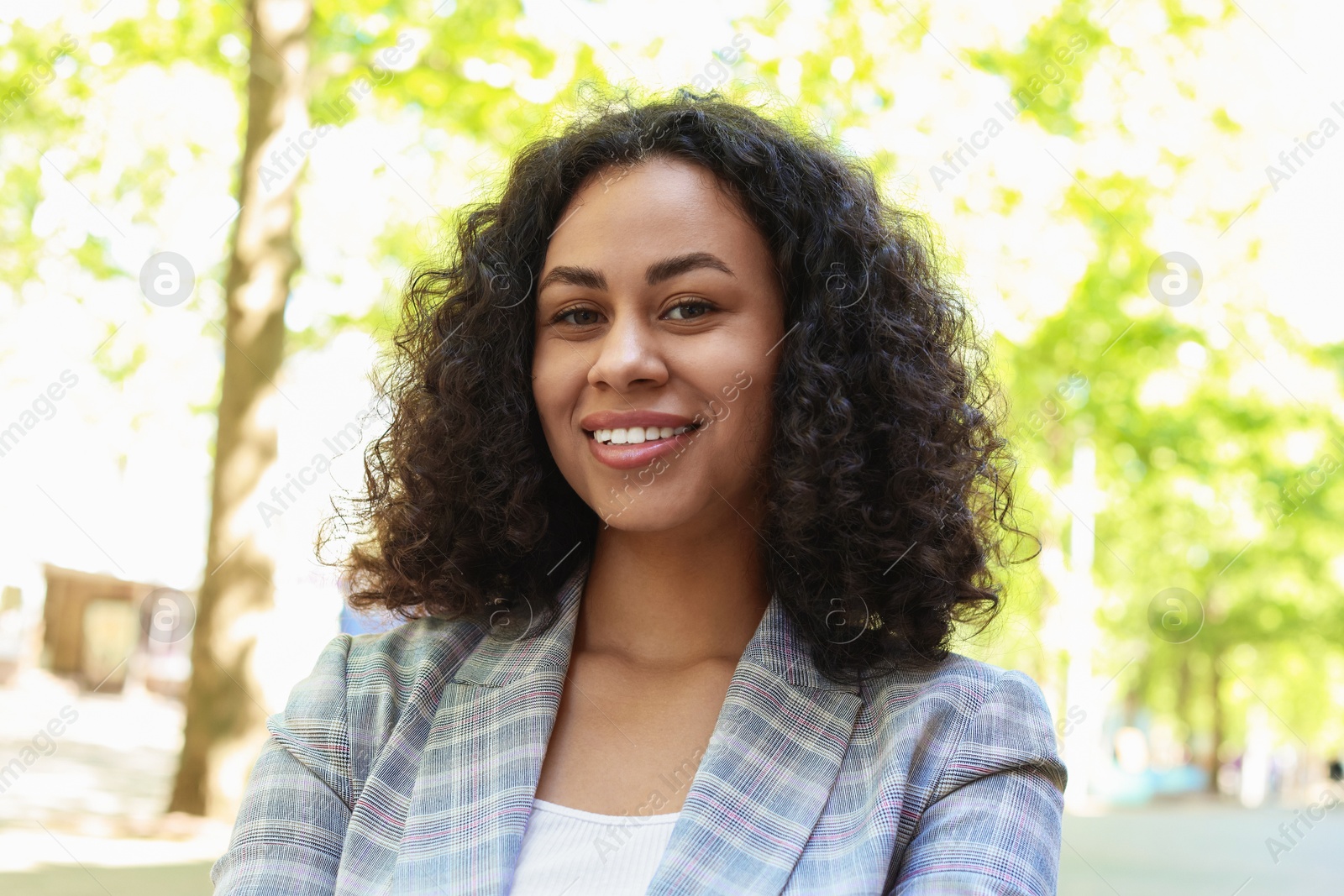 Portrait of smiling Latin American woman outdoors Photo of Portrait of smiling Latin American woman outdoors