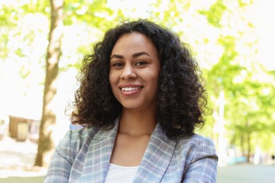 Photo of Portrait of smiling Latin American woman outdoors