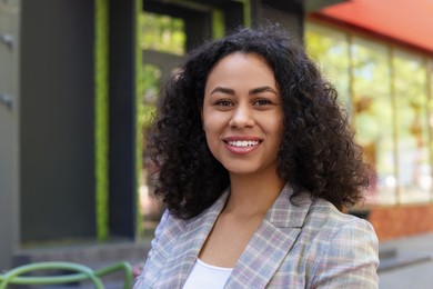 Photo of Portrait of smiling Latin American woman outdoors