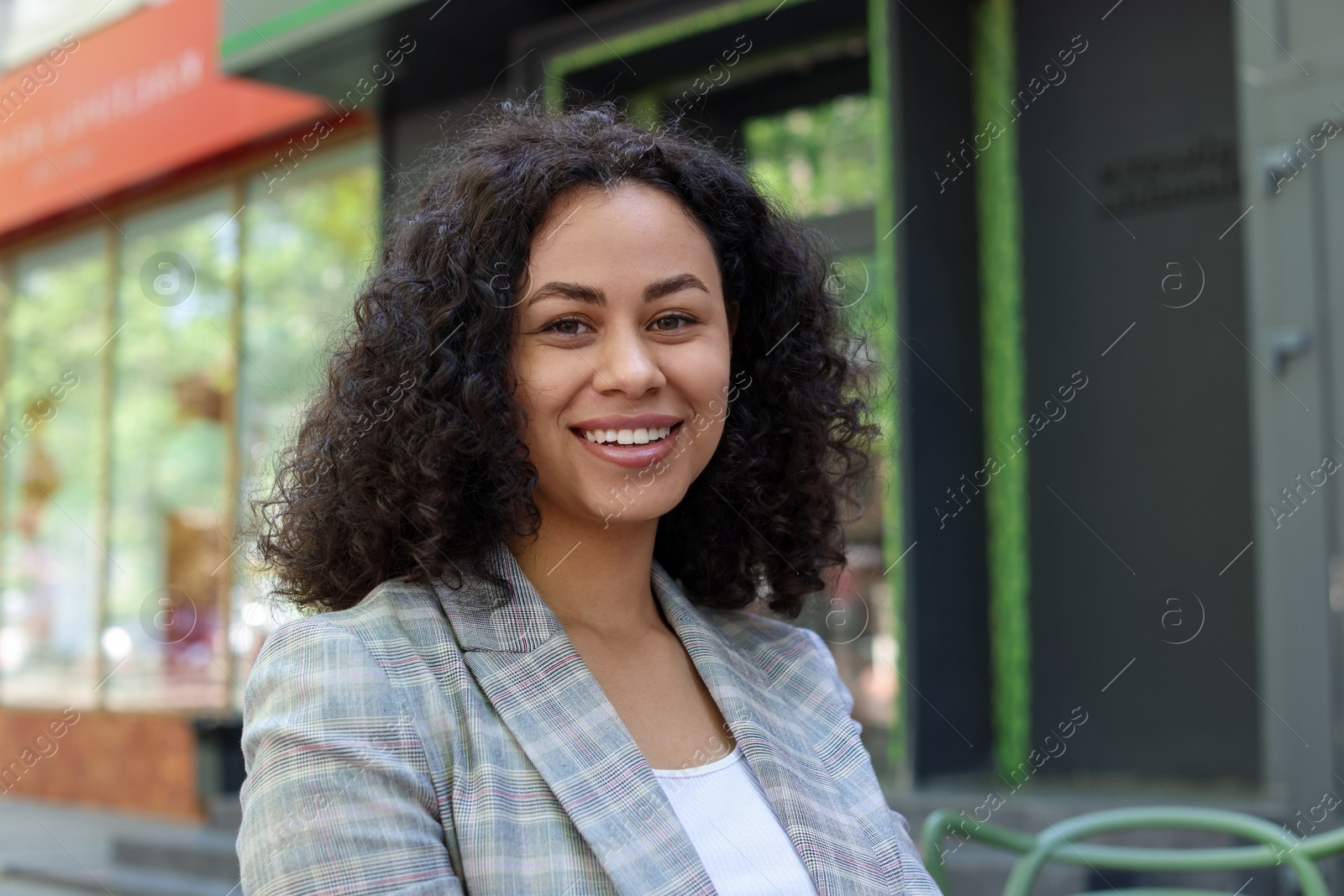 Portrait of smiling Latin American woman outdoors Photo of Portrait of smiling Latin American woman outdoors