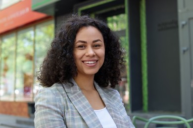 Photo of Portrait of smiling Latin American woman outdoors