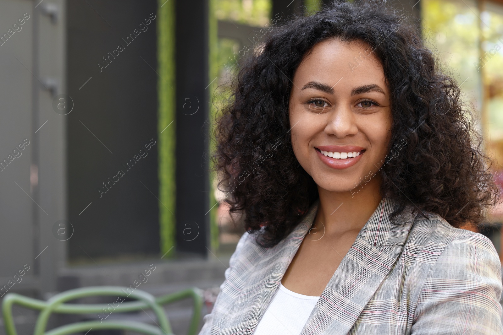 Portrait of smiling Latin American woman outdoors. Space for text Photo of Portrait of smiling Latin American woman outdoors. Space for text