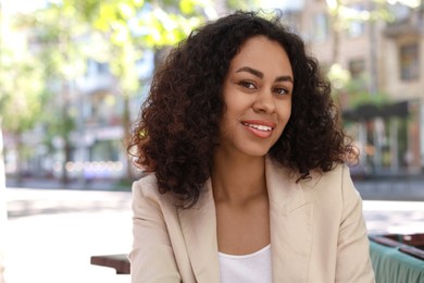 Photo of Portrait of smiling Latin American woman outdoors