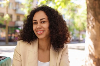 Photo of Portrait of smiling Latin American woman outdoors