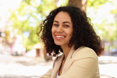Photo of Portrait of smiling Latin American woman outdoors