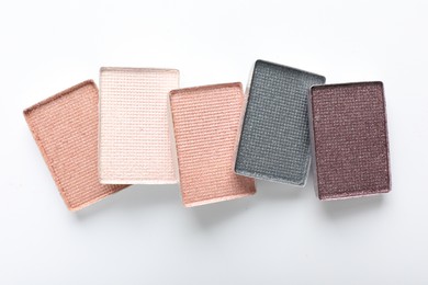 Photo of Beautiful eye shadow refill pans on white background, flat lay