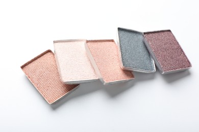 Photo of Beautiful eye shadow refill pans on white background, closeup