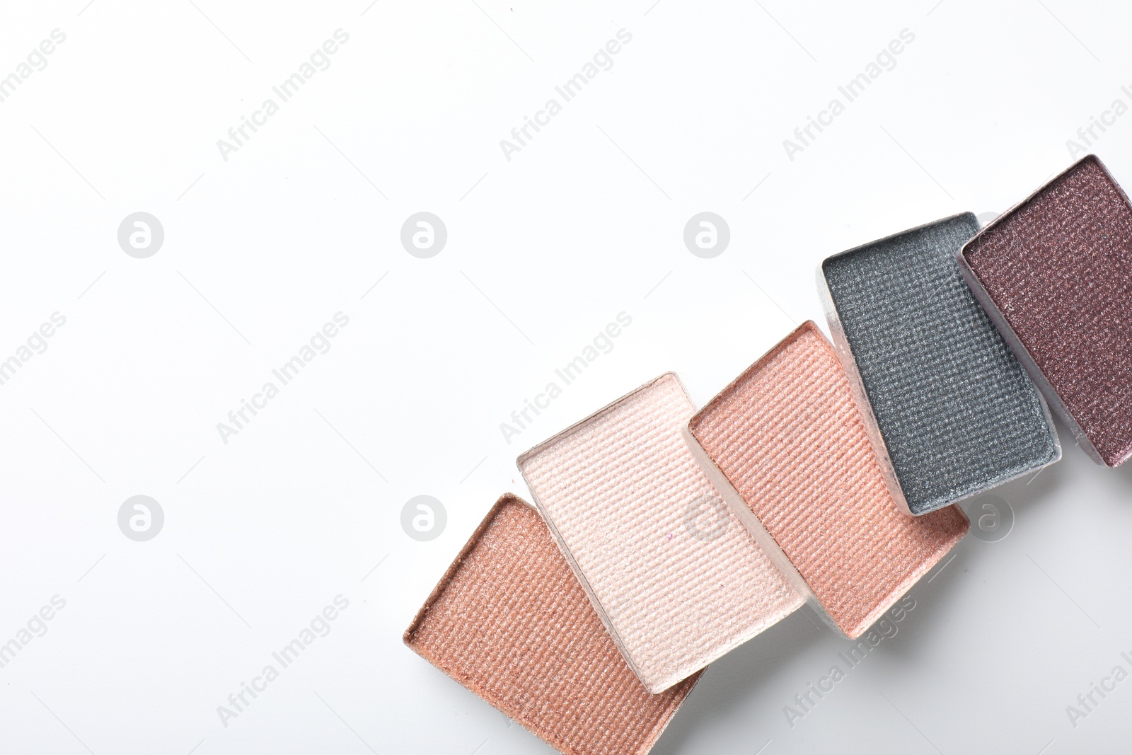 Beautiful eye shadow refill pans on white background, flat lay. Space for text Photo of Beautiful eye shadow refill pans on white background, flat lay. Space for text