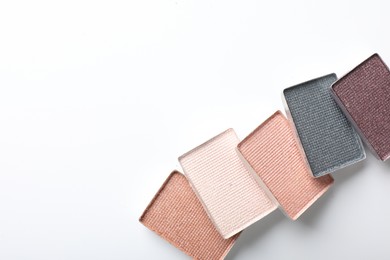 Photo of Beautiful eye shadow refill pans on white background, flat lay. Space for text