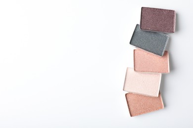 Photo of Beautiful eye shadow refill pans on white background, flat lay. Space for text