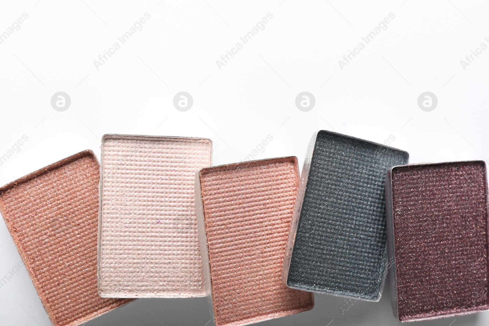 Beautiful eye shadow refill pans on white background, flat lay. Space for text Photo of Beautiful eye shadow refill pans on white background, flat lay. Space for text