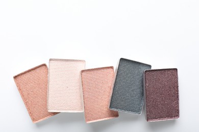 Photo of Beautiful eye shadow refill pans on white background, flat lay. Space for text