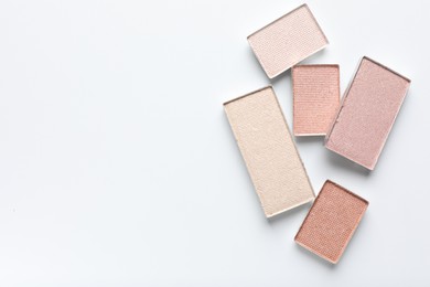 Photo of Beautiful eye shadow refill pans on white background, flat lay. Space for text