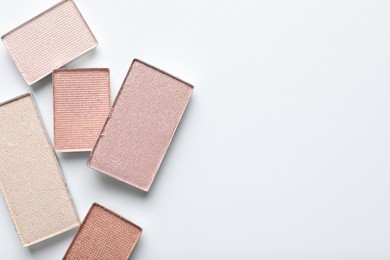 Photo of Beautiful eye shadow refill pans on white background, flat lay. Space for text