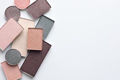 Photo of Beautiful eye shadow refill pans on white background, flat lay. Space for text