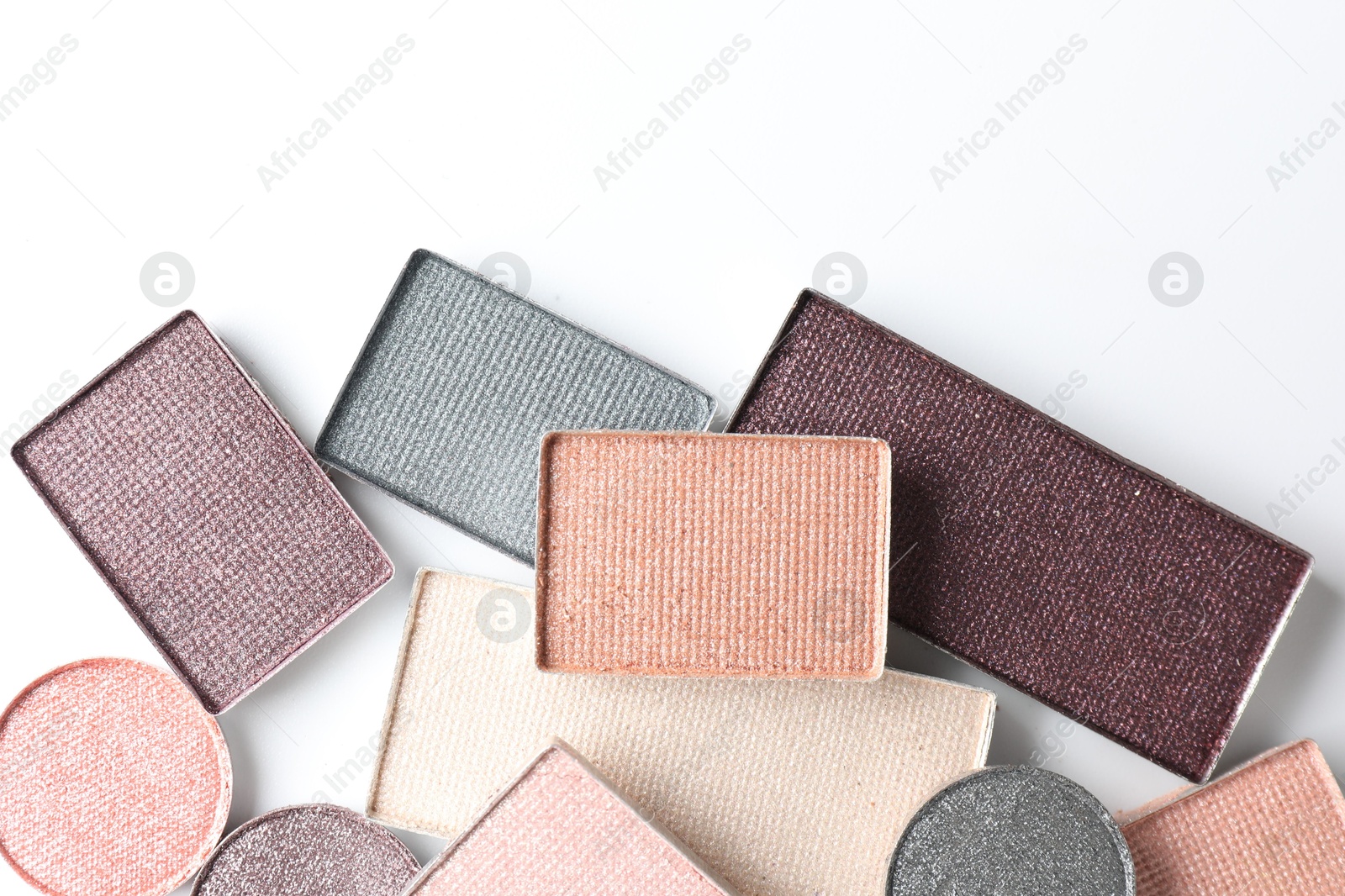 Photo of Beautiful eye shadow refill pans on white background, flat lay