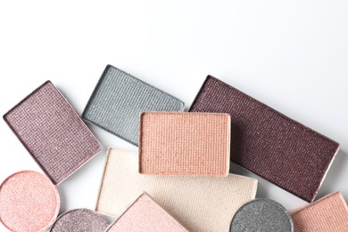 Photo of Beautiful eye shadow refill pans on white background, flat lay