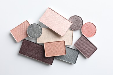 Photo of Beautiful eye shadow refill pans on white background, flat lay