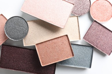 Photo of Beautiful eye shadow refill pans on white background, flat lay