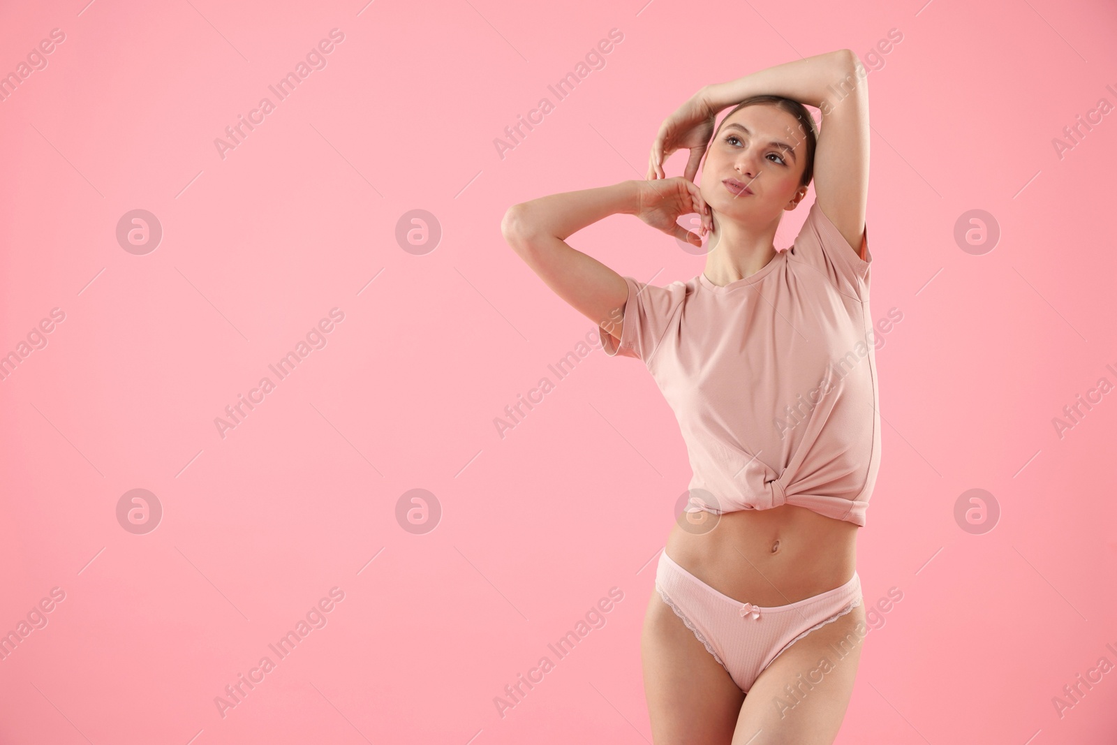 Woman wearing beautiful underwear on pink background, space for text Photo of Woman wearing beautiful underwear on pink background, space for text