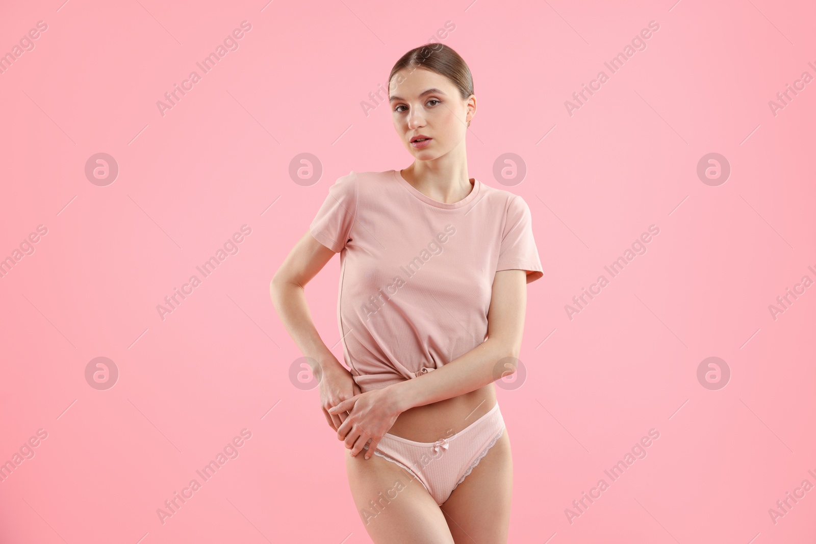 Woman wearing beautiful underwear on pink background Photo of Woman wearing beautiful underwear on pink background
