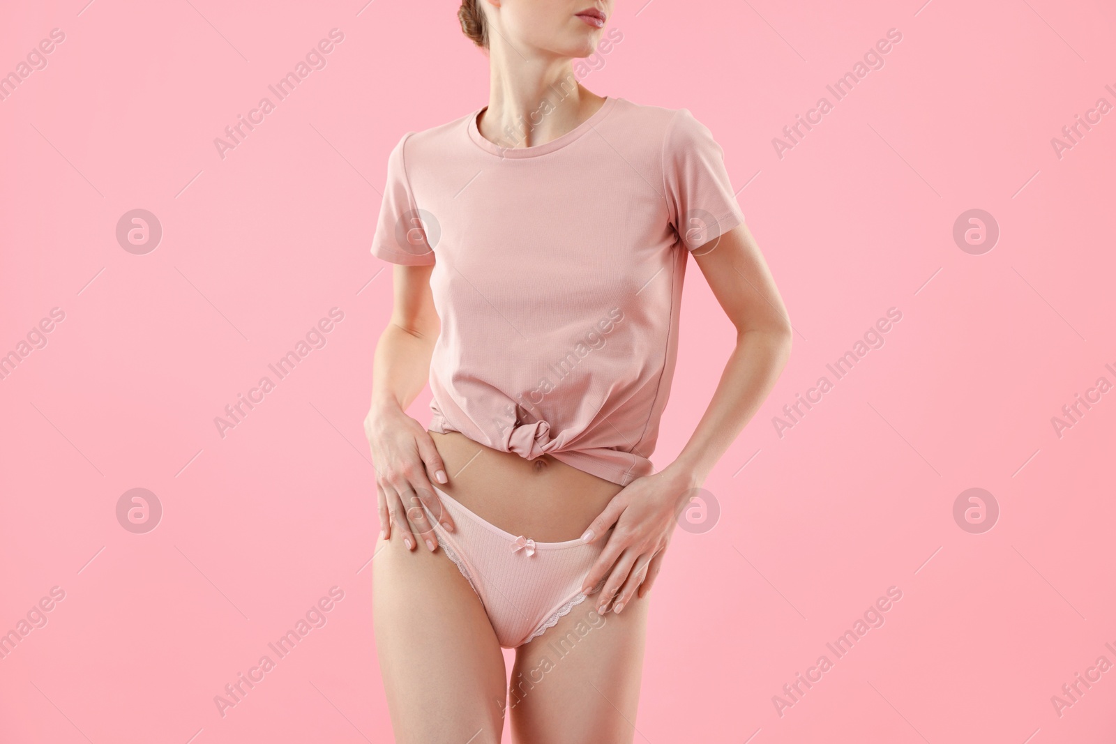 Woman wearing beautiful underwear on pink background, closeup Photo of Woman wearing beautiful underwear on pink background, closeup