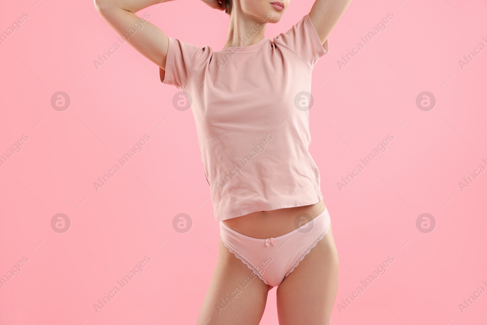 Woman wearing beautiful underwear on pink background, closeup Photo of Woman wearing beautiful underwear on pink background, closeup