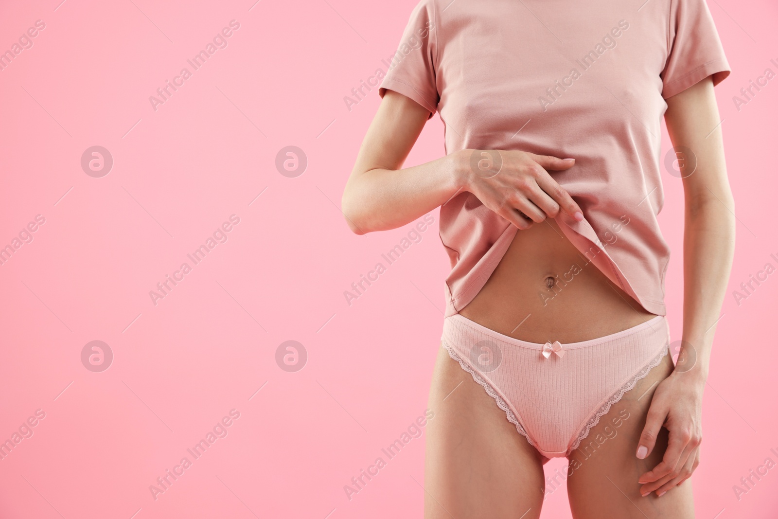 Woman wearing beautiful underwear on pink background, closeup. Space for text Photo of Woman wearing beautiful underwear on pink background, closeup. Space for text