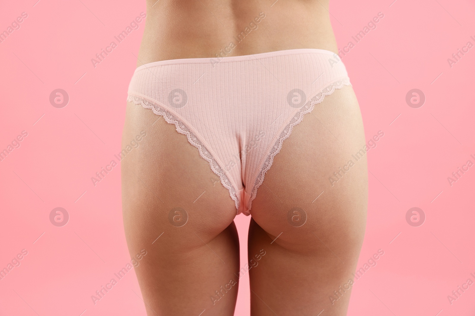 Woman wearing beautiful underwear on pink background, closeup Photo of Woman wearing beautiful underwear on pink background, closeup