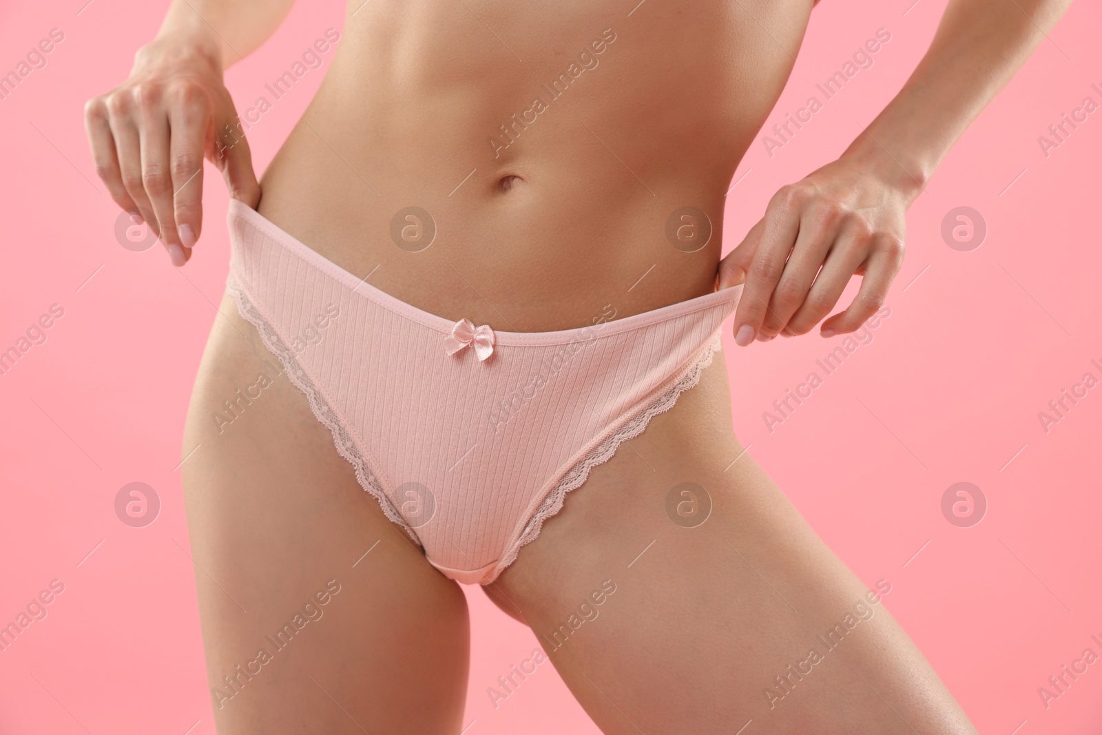 Woman wearing beautiful underwear on pink background, closeup Photo of Woman wearing beautiful underwear on pink background, closeup