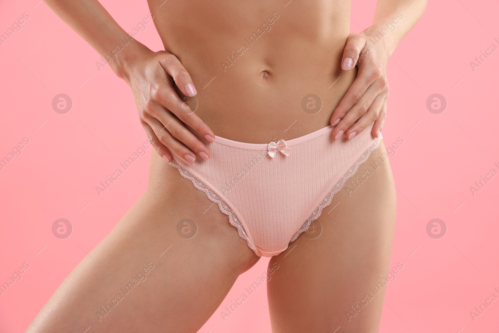 Woman wearing beautiful underwear on pink background, closeup Photo of Woman wearing beautiful underwear on pink background, closeup