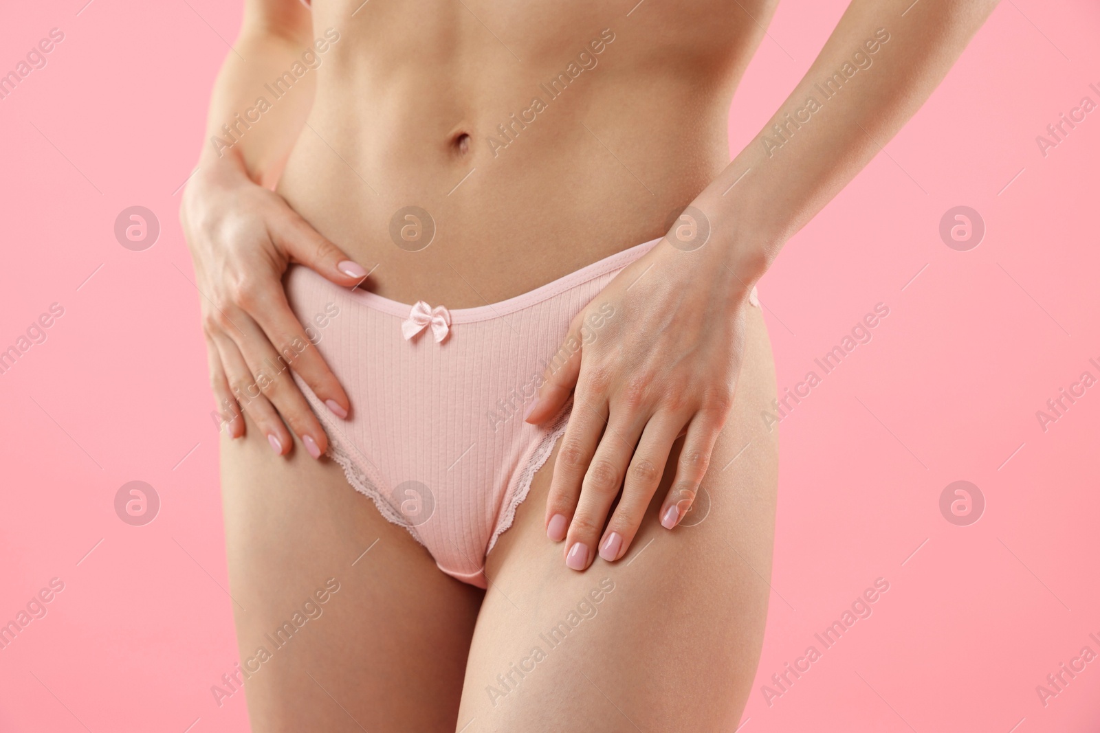 Woman wearing beautiful underwear on pink background, closeup Photo of Woman wearing beautiful underwear on pink background, closeup