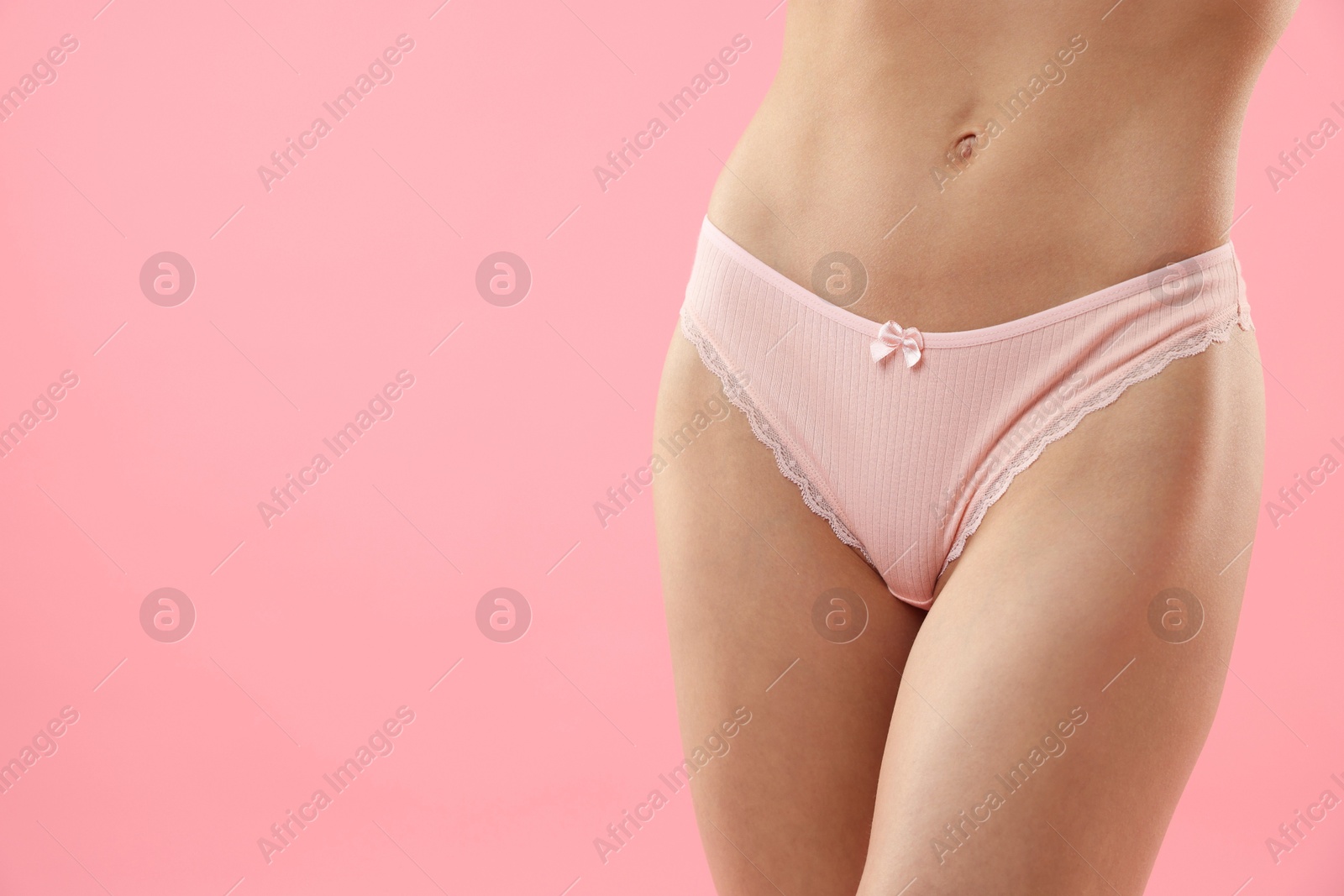 Woman wearing beautiful underwear on pink background, closeup. Space for text Photo of Woman wearing beautiful underwear on pink background, closeup. Space for text