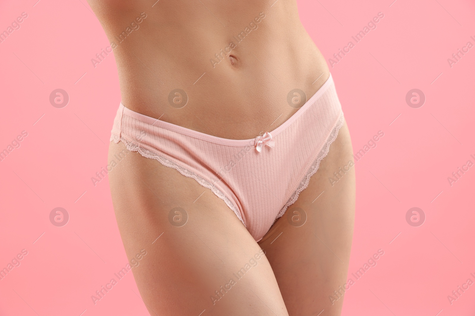 Woman wearing beautiful underwear on pink background, closeup Photo of Woman wearing beautiful underwear on pink background, closeup