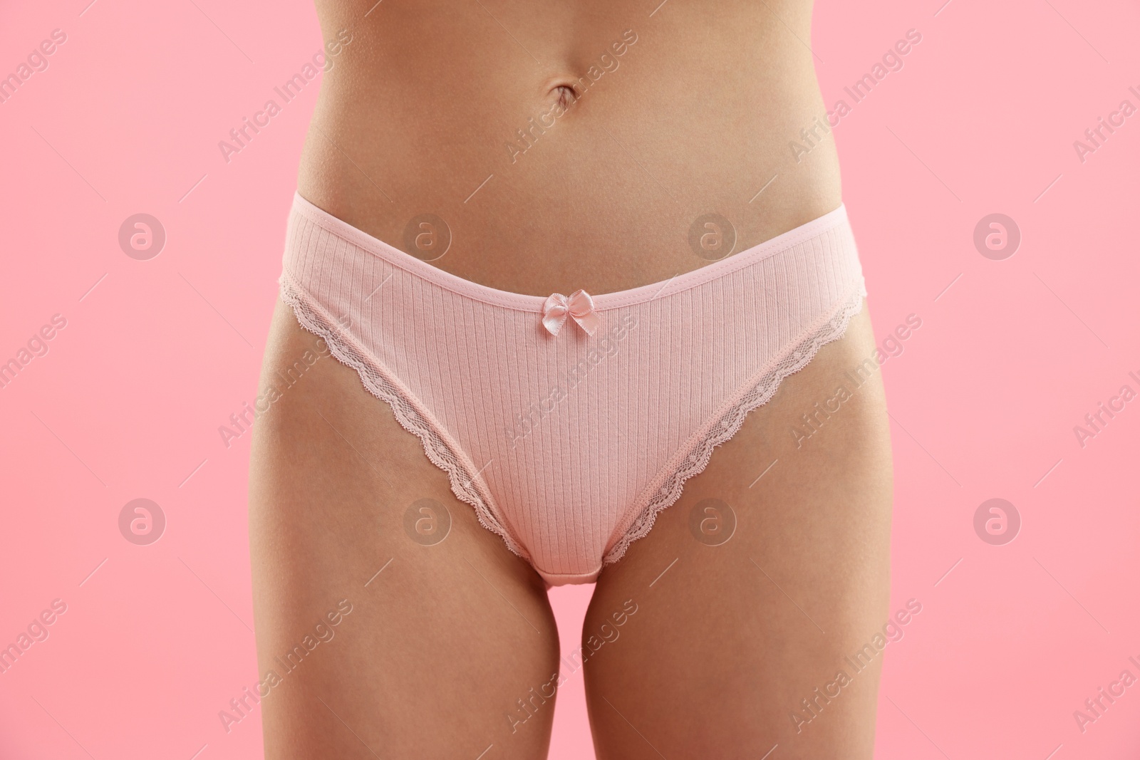 Woman wearing beautiful underwear on pink background, closeup Photo of Woman wearing beautiful underwear on pink background, closeup