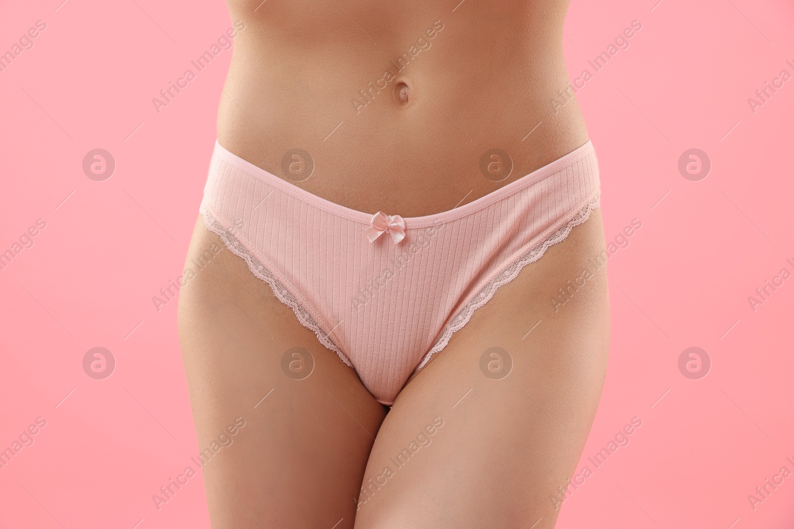 Woman wearing beautiful underwear on pink background, closeup Photo of Woman wearing beautiful underwear on pink background, closeup