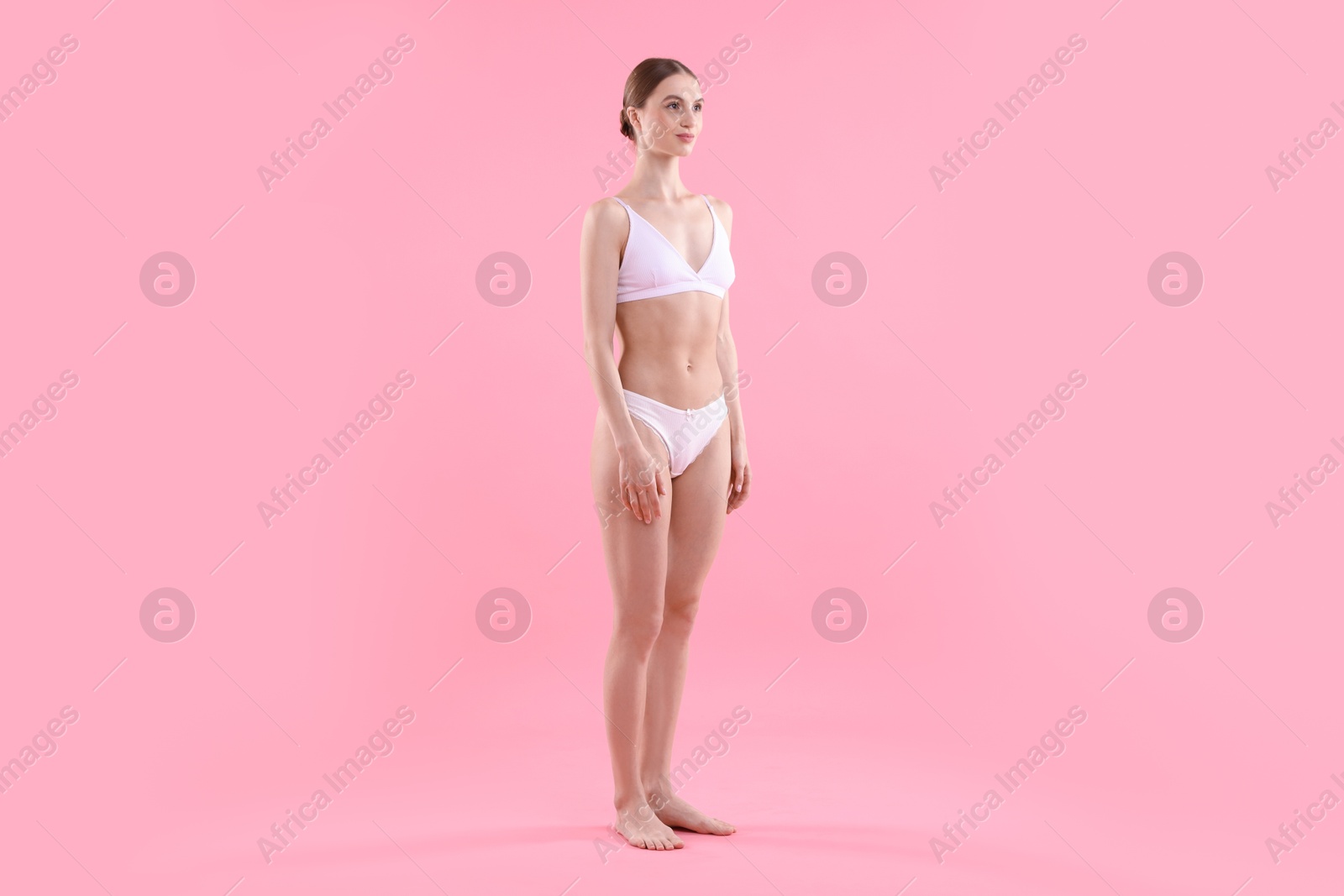 Woman wearing beautiful underwear on pink background Photo of Woman wearing beautiful underwear on pink background