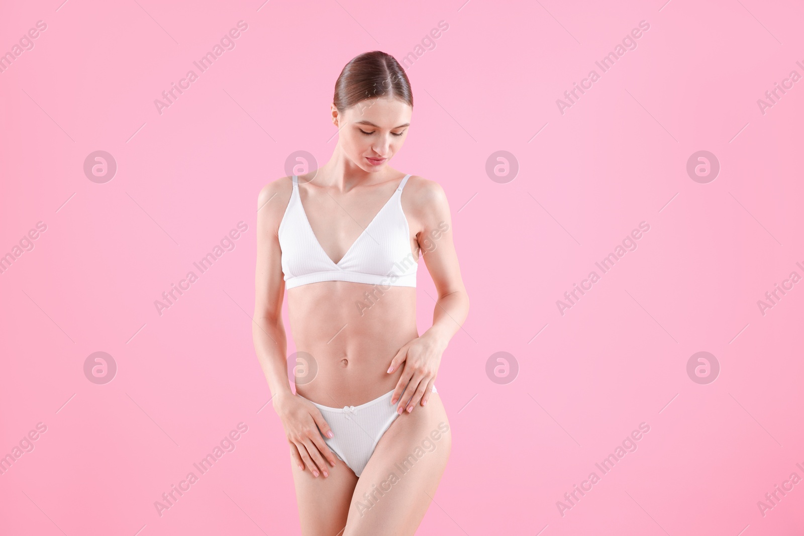 Woman wearing beautiful underwear on pink background Photo of Woman wearing beautiful underwear on pink background