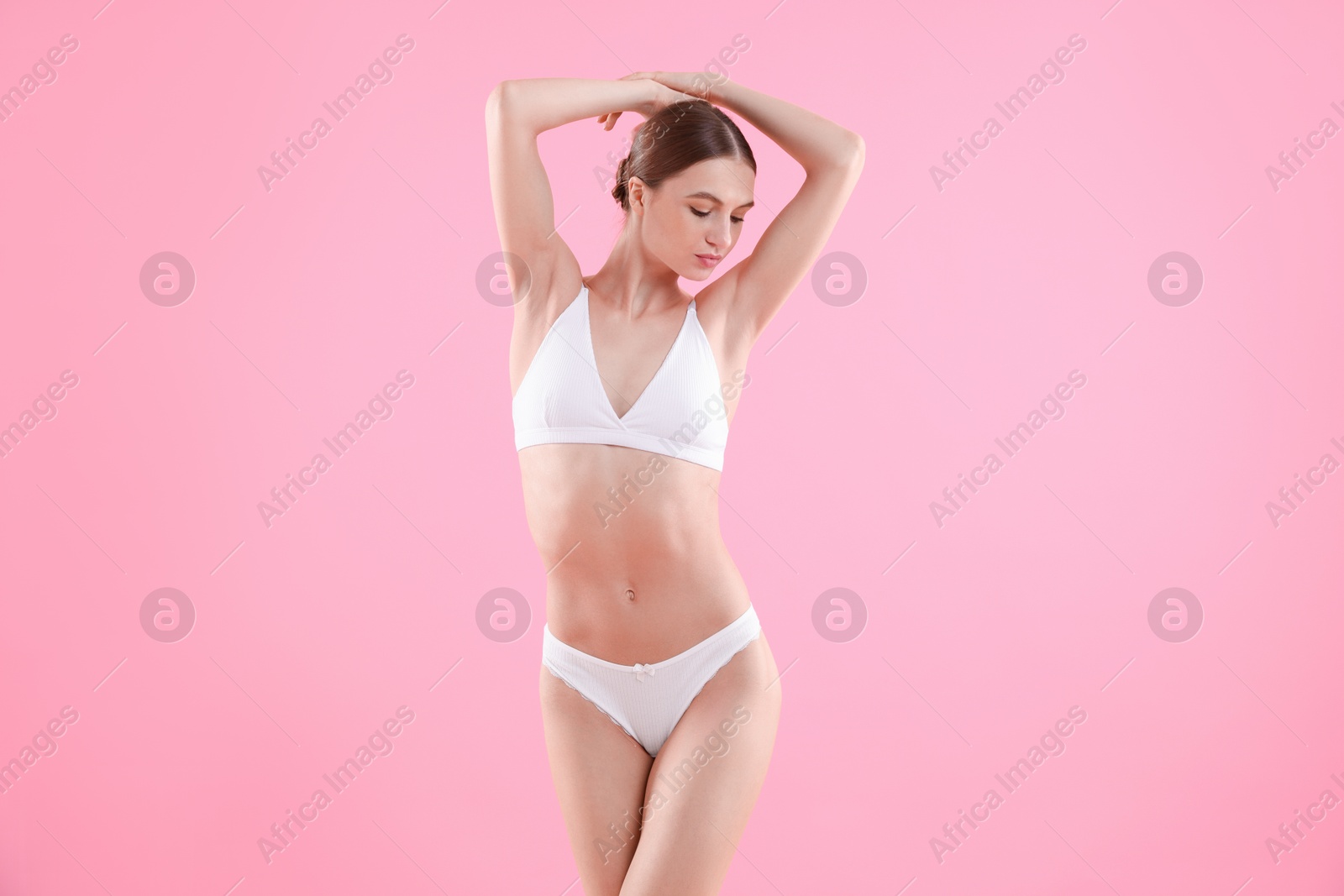 Woman wearing beautiful underwear on pink background Photo of Woman wearing beautiful underwear on pink background