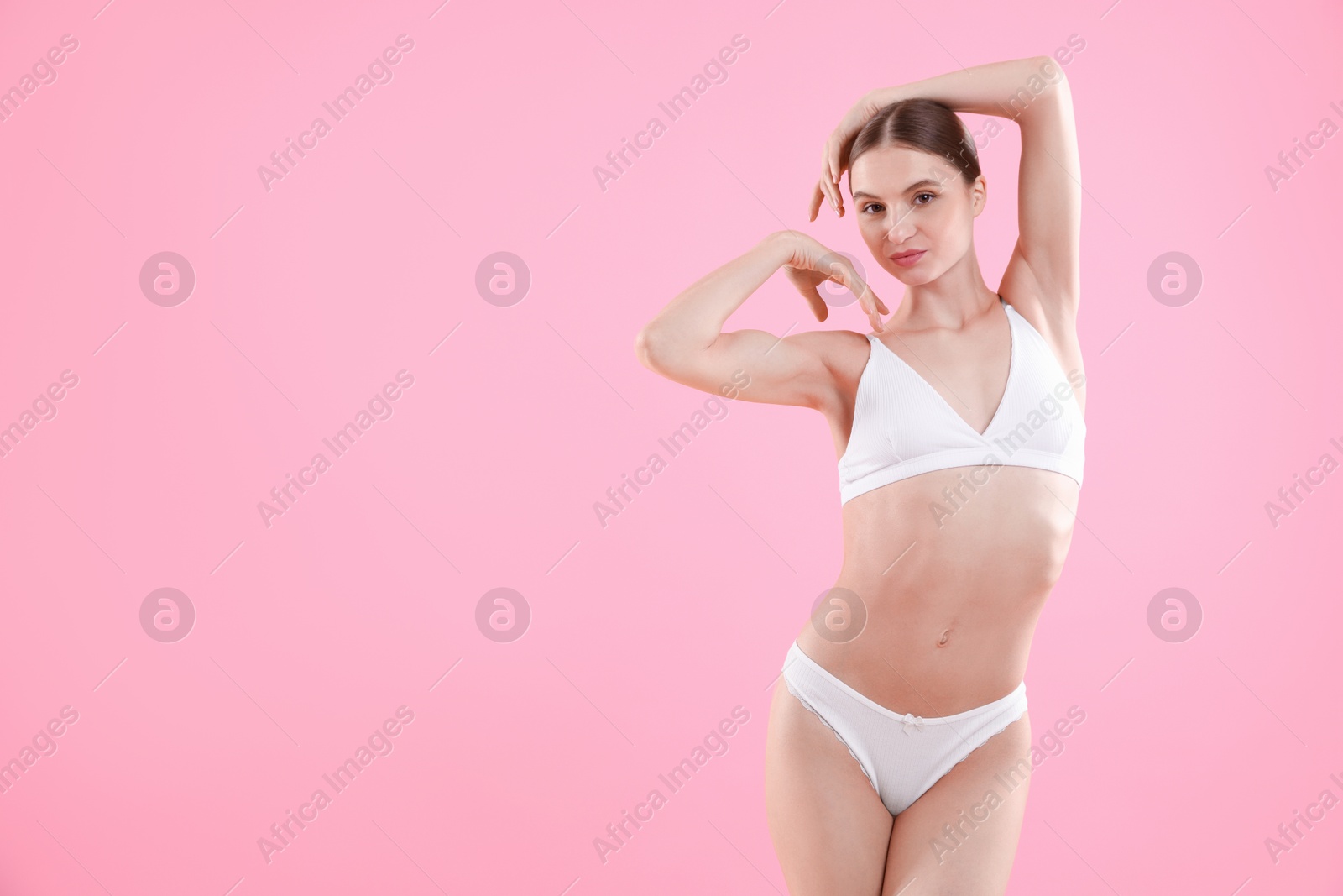 Woman wearing beautiful underwear on pink background, space for text Photo of Woman wearing beautiful underwear on pink background, space for text